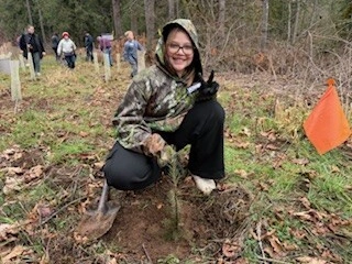 pictures of elementary school children helping plant trees at Hopkins Demonstration forest with Mike Biondi, Cliff Puckett, and other volunteers.